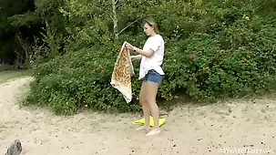 A young woman enjoys self-pleasure in the open air